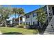 Exterior view of an apartment building with lush landscaping at 7622 Forest City Rd # E, Orlando, FL 32810