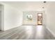 Spacious living room with light gray vinyl flooring and a wood door at 3137 Sw 127Th Lane Rd, Ocala, FL 34473