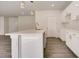 Modern kitchen with white cabinets, quartz countertops, and a kitchen island at 1308 Hillsborough Ct, Kissimmee, FL 34759