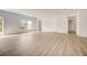 Spacious living room featuring light wood-look flooring and large windows at 1308 Hillsborough Ct, Kissimmee, FL 34759