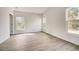 Spacious bedroom with wood-look floors and large windows at 1308 Hillsborough Ct, Kissimmee, FL 34759