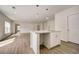Modern kitchen island with white cabinets and quartz countertops at 1308 Hillsborough Ct, Kissimmee, FL 34759