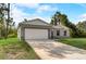Modern two-car garage with gray siding and white trim at 1308 Hillsborough Ct, Kissimmee, FL 34759