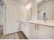 Modern bathroom with double vanity and white cabinets at 1308 Hillsborough Ct, Kissimmee, FL 34759