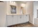 Bathroom with double vanity, large mirrors, and marble shower at 1308 Hillsborough Ct, Kissimmee, FL 34759