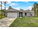 Single-story home with gray exterior and white garage door at 1308 Hillsborough Ct, Kissimmee, FL 34759