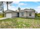 New construction home with gray siding and a large yard at 1308 Hillsborough Ct, Kissimmee, FL 34759