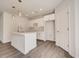 Modern white kitchen with an island and pendant lighting at 1308 Hillsborough Ct, Kissimmee, FL 34759