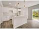 Modern kitchen with white cabinets and island at 1308 Hillsborough Ct, Kissimmee, FL 34759