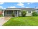 Ranch home with a covered porch and lush green lawn at 106 Oregon Ave, Saint Cloud, FL 34769