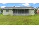 Large backyard with a spacious screened porch at 106 Oregon Ave, Saint Cloud, FL 34769