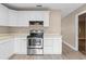Eat-in kitchen with white cabinets and stainless steel appliances at 106 Oregon Ave, Saint Cloud, FL 34769