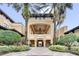 Elegant resort entrance with landscaping and covered walkway at 12556 Floridays Resort Dr # 207-A, Orlando, FL 32821