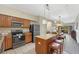 Open concept kitchen with granite countertops and wood cabinets at 12556 Floridays Resort Dr # 207-A, Orlando, FL 32821