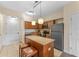 Modern kitchen with stainless steel appliances and island at 12556 Floridays Resort Dr # 207-A, Orlando, FL 32821