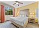 Main bedroom with king-size bed and ceiling fan at 12556 Floridays Resort Dr # 207-A, Orlando, FL 32821