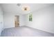 Bright bedroom with grey laminate floors and ceiling fan at 168 E Sunset St, Groveland, FL 34736