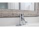 Close-up of a chrome faucet in a modern bathroom setting at 168 E Sunset St, Groveland, FL 34736