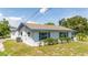 Side view of single story home, white with blue trim at 168 E Sunset St, Groveland, FL 34736