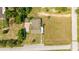 Aerial view of a house and surrounding property, showcasing ample backyard space at 168 E Sunset St, Groveland, FL 34736