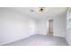 Spacious bedroom featuring grey flooring and a ceiling fan at 168 E Sunset St, Groveland, FL 34736