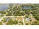 Aerial view of a home in a residential neighborhood near a lake at 168 E Sunset St, Groveland, FL 34736