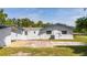 Back of house showing shed and yard at 168 E Sunset St, Groveland, FL 34736