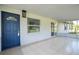 Screened porch entry with blue door and tile floor at 168 E Sunset St, Groveland, FL 34736