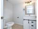 Updated bathroom features a white vanity, a large mirror, and tile flooring at 168 E Sunset St, Groveland, FL 34736