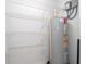 Storage room with shelving and water heater at 168 E Sunset St, Groveland, FL 34736