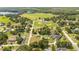 Aerial view showing home's location in a quiet residential neighborhood with nearby park at 168 E Sunset St, Groveland, FL 34736