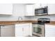 Updated kitchen with stainless steel appliances and white cabinets at 168 E Sunset St, Groveland, FL 34736