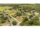 Aerial view of home nestled in a community with lake and park nearby at 168 E Sunset St, Groveland, FL 34736