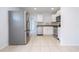 Modern kitchen featuring stainless steel appliances and tile floors at 168 E Sunset St, Groveland, FL 34736
