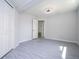 Spacious bedroom with gray flooring and access to another room at 168 E Sunset St, Groveland, FL 34736