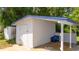 White storage shed with covered patio area at 168 E Sunset St, Groveland, FL 34736