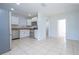 Open concept kitchen with stainless steel appliances and view into dining area at 168 E Sunset St, Groveland, FL 34736