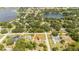 Aerial view showing a home near a lake and a baseball field at 168 E Sunset St, Groveland, FL 34736