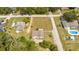 Aerial view of a house with a large yard and a swimming pool nearby at 168 E Sunset St, Groveland, FL 34736