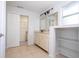 Double vanity bathroom with beige tile floor and walk-in closet at 168 E Sunset St, Groveland, FL 34736