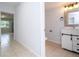 Updated bathroom with modern vanity and tile floor at 168 E Sunset St, Groveland, FL 34736