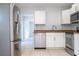 Bright kitchen, stainless steel appliances, and tile flooring at 168 E Sunset St, Groveland, FL 34736