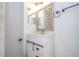 White vanity with a farmhouse sink and unique mirror at 168 E Sunset St, Groveland, FL 34736
