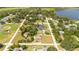 Aerial view of a home in a residential neighborhood by a lake at 168 E Sunset St, Groveland, FL 34736