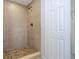 Large tiled shower with neutral tones and mosaic floor at 168 E Sunset St, Groveland, FL 34736