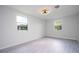 Bright bedroom with grey laminate floors and ceiling fan at 168 E Sunset St, Groveland, FL 34736