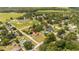 Aerial view showcasing a single Gathering home near a baseball field and lake at 168 E Sunset St, Groveland, FL 34736