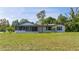 Front view of a single story home with a screened porch at 168 E Sunset St, Groveland, FL 34736
