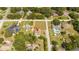 Aerial view of a home in a residential neighborhood by a lake at 168 E Sunset St, Groveland, FL 34736