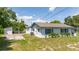 View of back of house, detached shed, and yard at 168 E Sunset St, Groveland, FL 34736